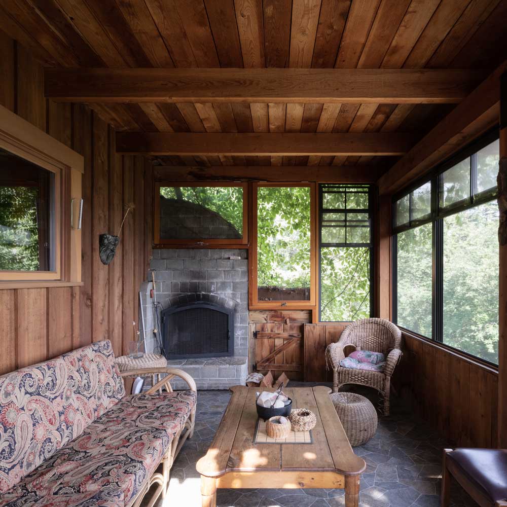 A covered porch in the Lavender Cabin at Tin Poppy Retreat.