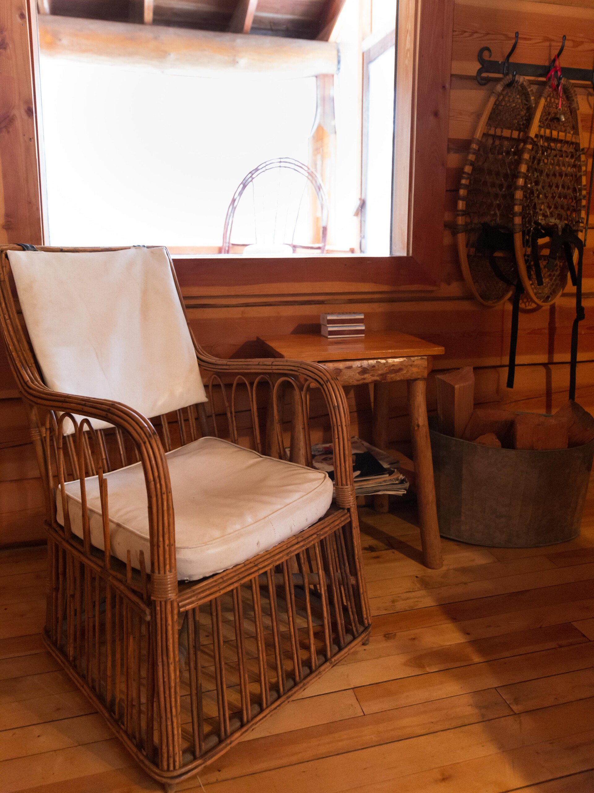 A wicker chair and snowshoes.