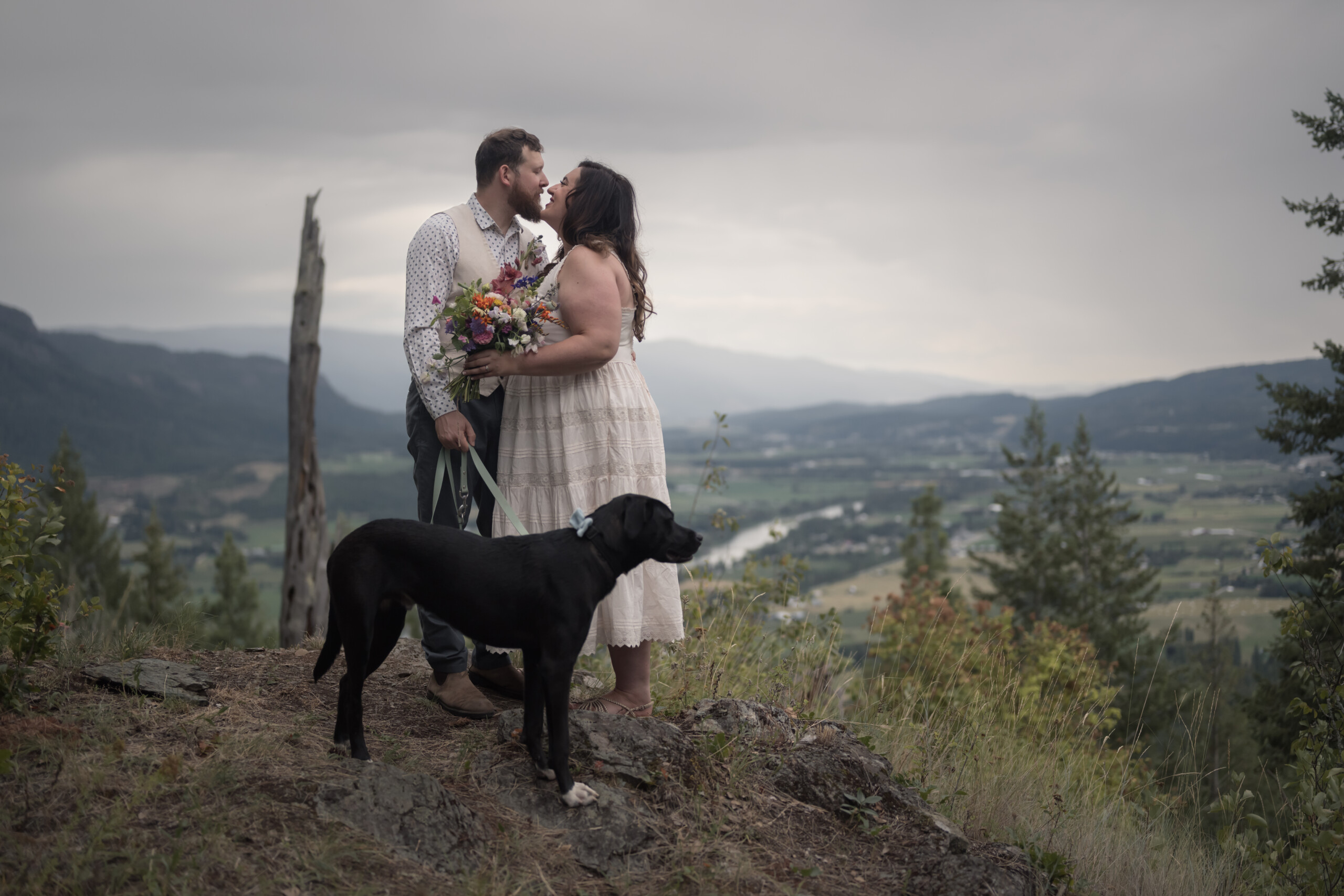Bride and groom with their dog.